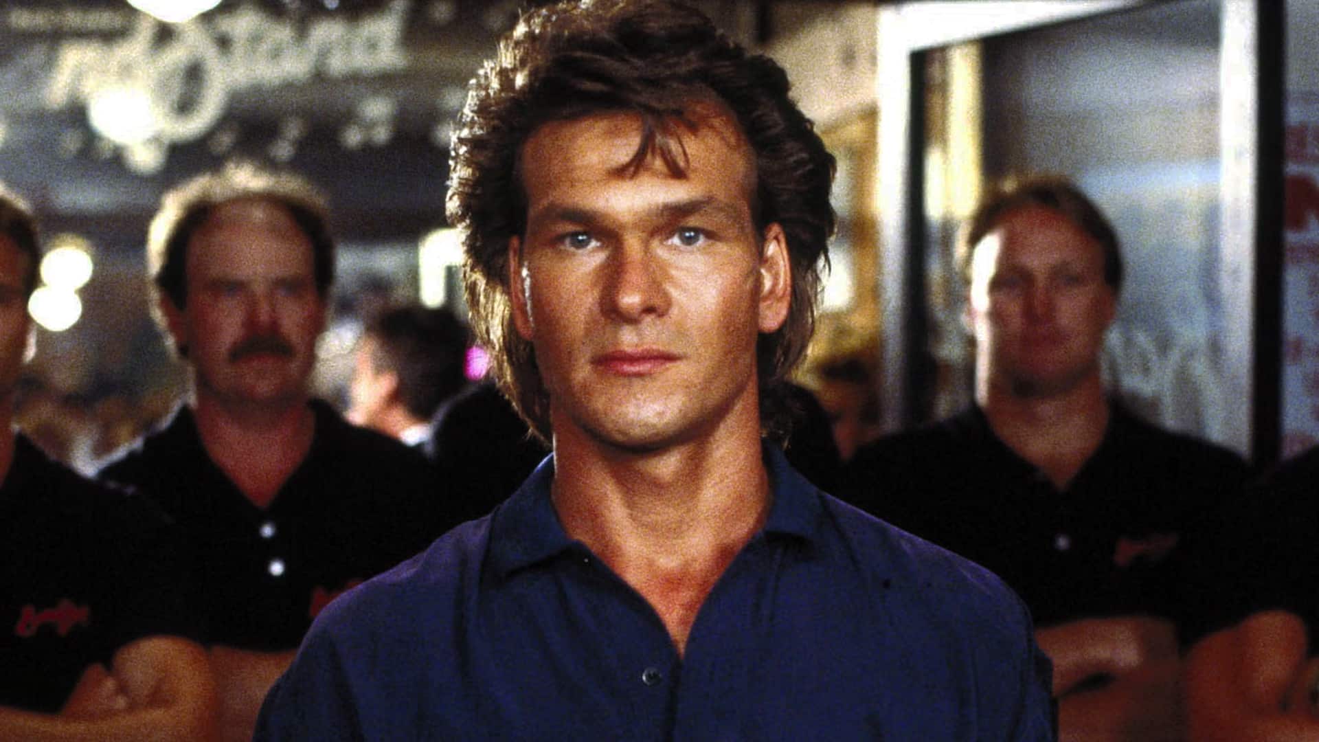 Patrick Swayze in a movie scene, the Hollywood star who nearly lost his leg at 18 before becoming an iconic dancer and actor.