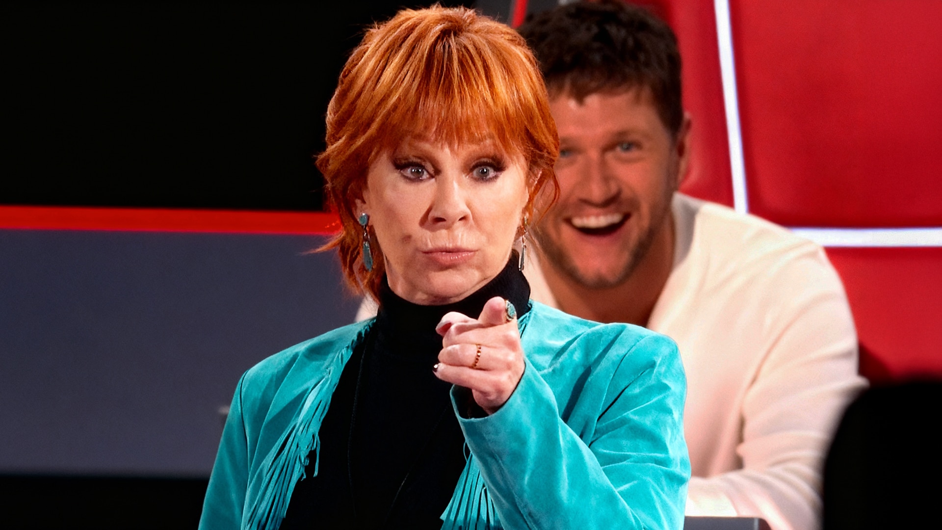 Reba McEntire reacts with humor after being blocked by Snoop Dogg on The Voice, turning the moment into playful banter.