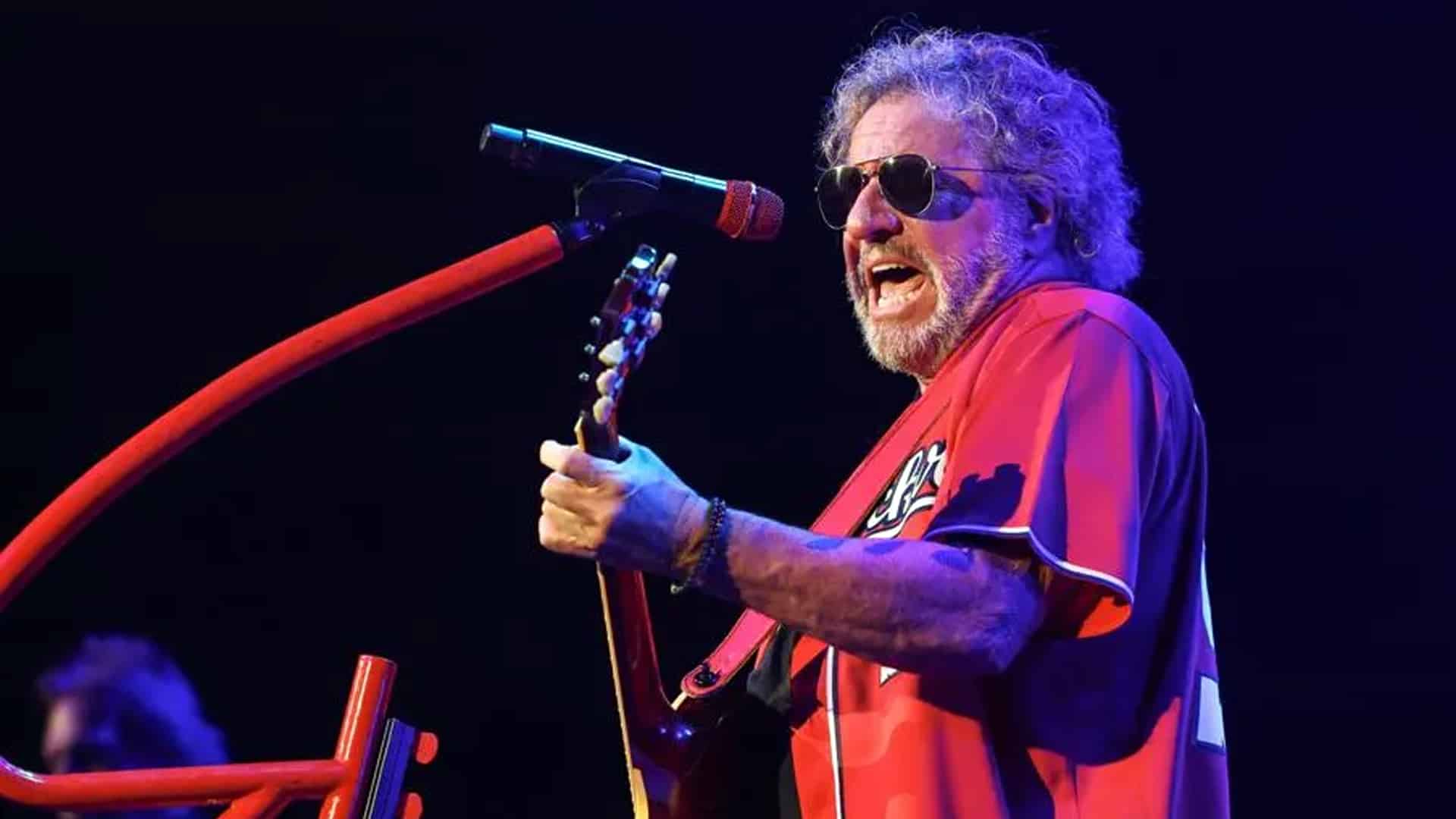 Sammy Hagar sings and plays guitar under stage lights, dedicating Merle Haggard’s “Are the Good Times Really Over” to Charlie Kirk.
