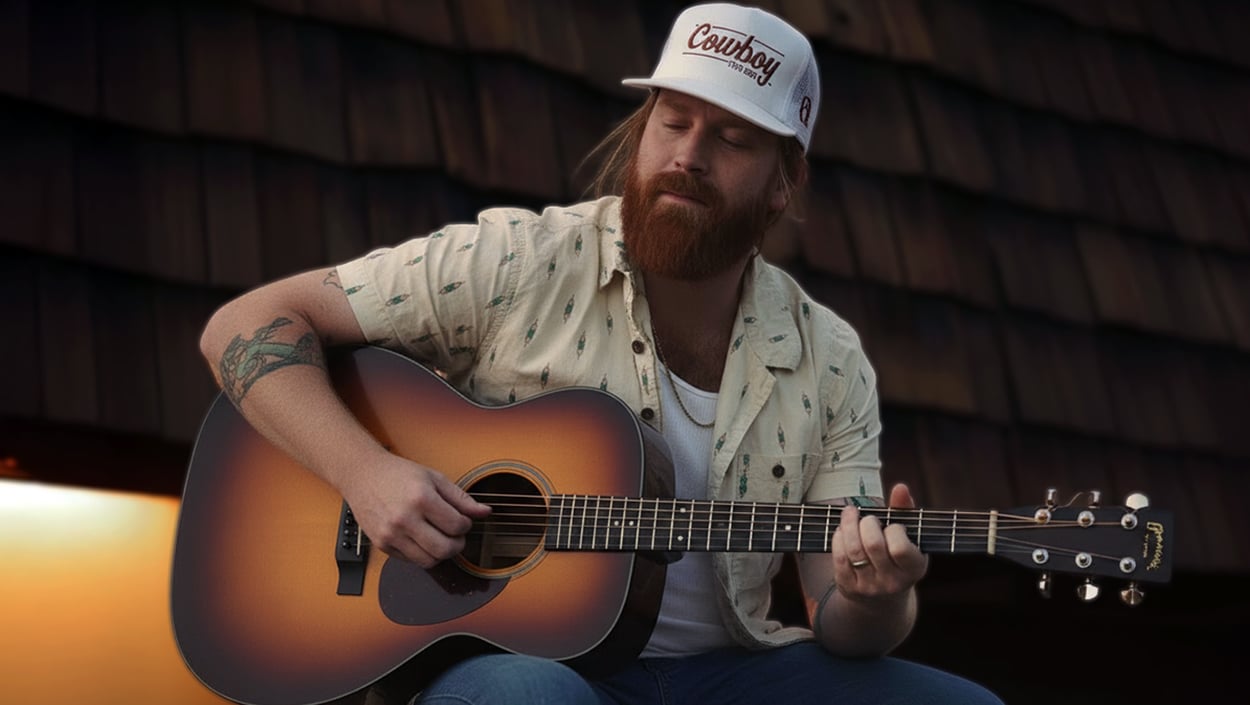 Texas country singer Mitchell Ferguson playing guitar, honoring Charlie Kirk with a heartfelt tribute ballad.