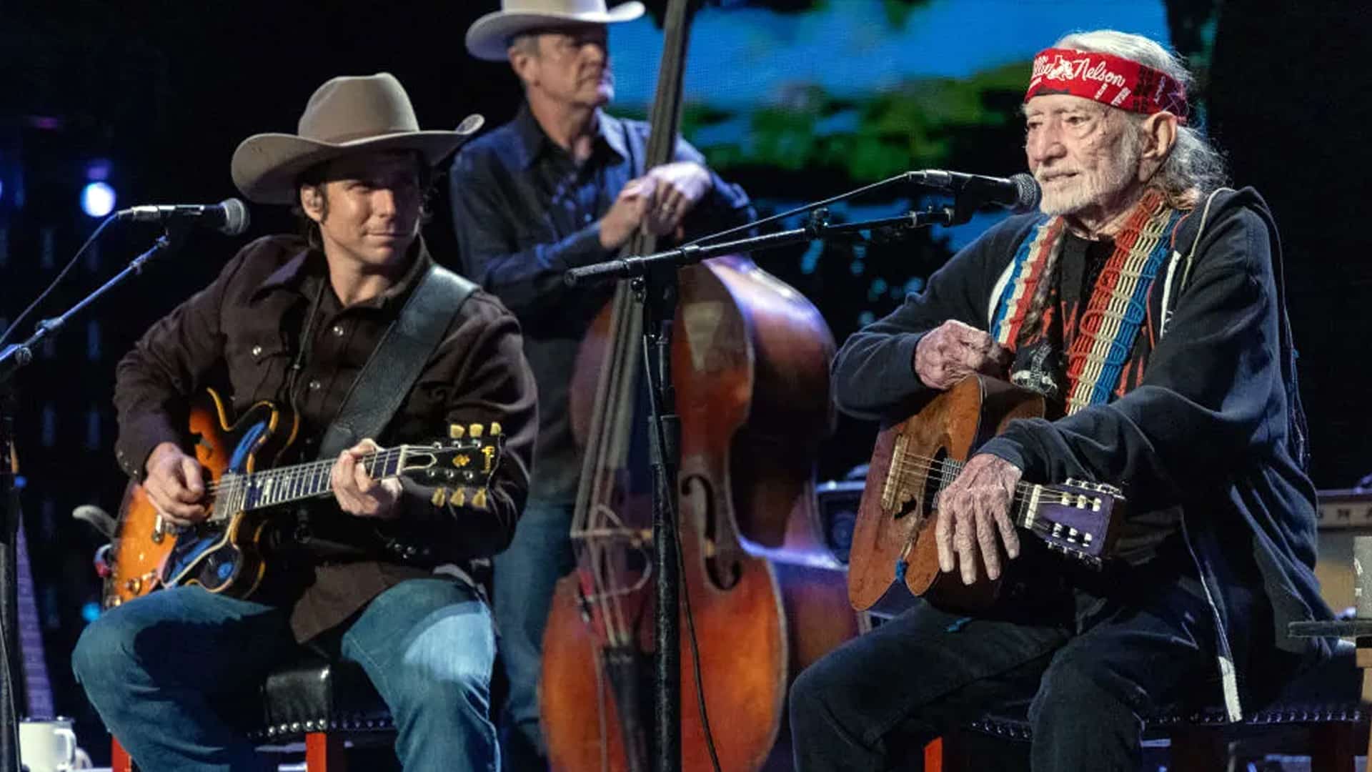 Willie Nelson and son Lukas Nelson performing together at Farm Aid, sharing an emotional father-son duet of “Just Breathe.”