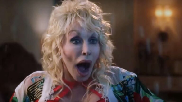 Country legend Dolly Parton appearing shocked, illustrating her eerie story about unexplained footsteps and faucets turning on by themselves.