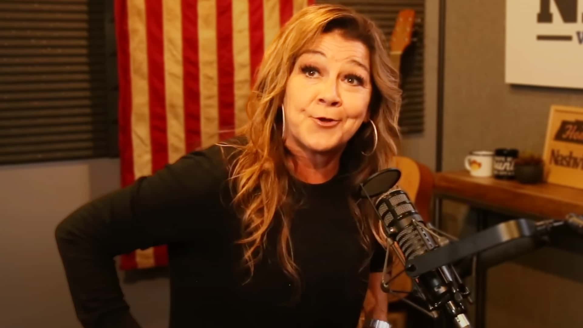 Gretchen Wilson speaking animatedly into a studio mic, doubling down on her bold take that today’s country men need to toughen up.