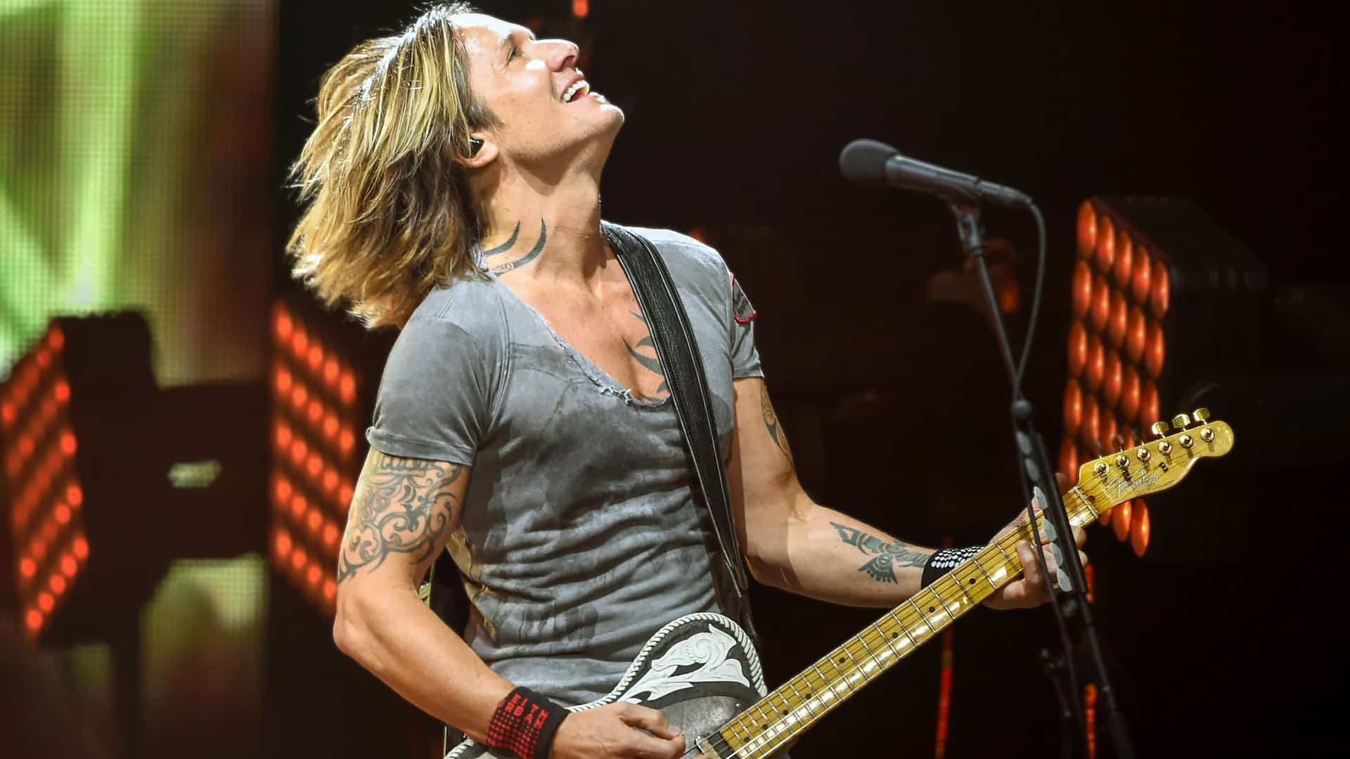 Keith Urban rocking out on guitar in Hershey, where he shocked fans by swapping “reasons” for “bulls* reasons” in You’ll Think of Me.