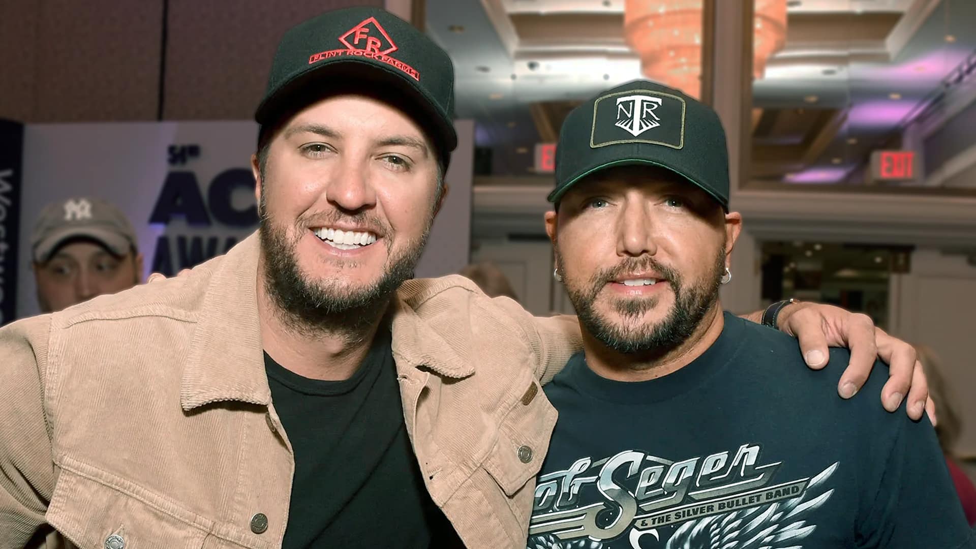 Luke Bryan and Jason Aldean smiling together, reuniting ahead of their Sanford Stadium concert return in 2026.