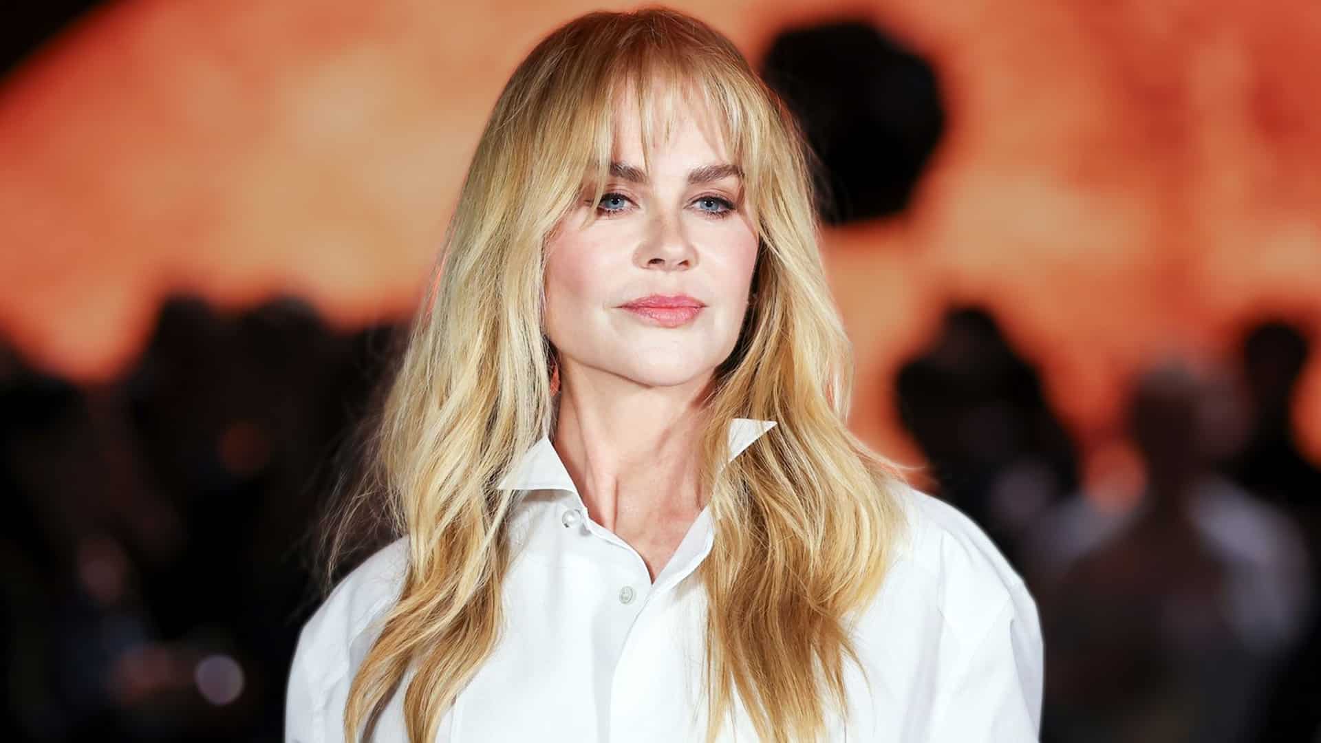 Nicole Kidman in a white blouse with soft waves and new bangs, exuding quiet strength as her pre-divorce Vogue interview resurfaces with subtle hints of change.