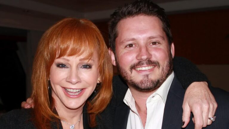 Reba McEntire smiling beside her late stepson Brandon Blackstock, a bittersweet image as she reflects on his life and the bond they shared.