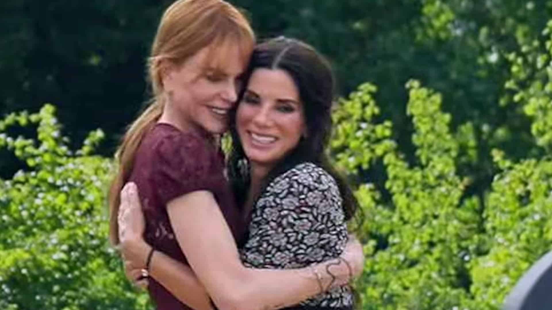 Nicole Kidman and Sandra Bullock sharing a warm hug outdoors, celebrating their enduring friendship as Bullock praises Kidman’s strength amid her divorce.