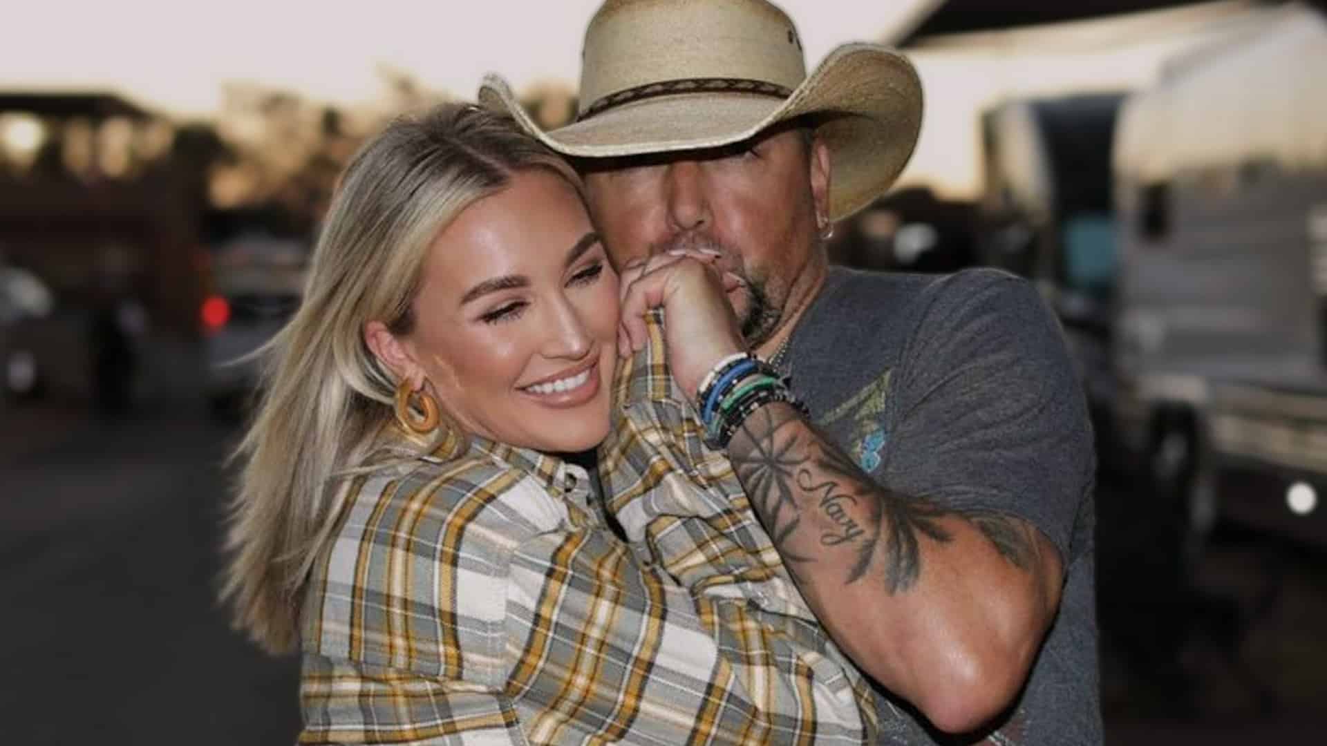 Country star Jason Aldean kisses Brittany Aldean’s hand with a smile, marking their new musical chapter together on “Easier Gone.”