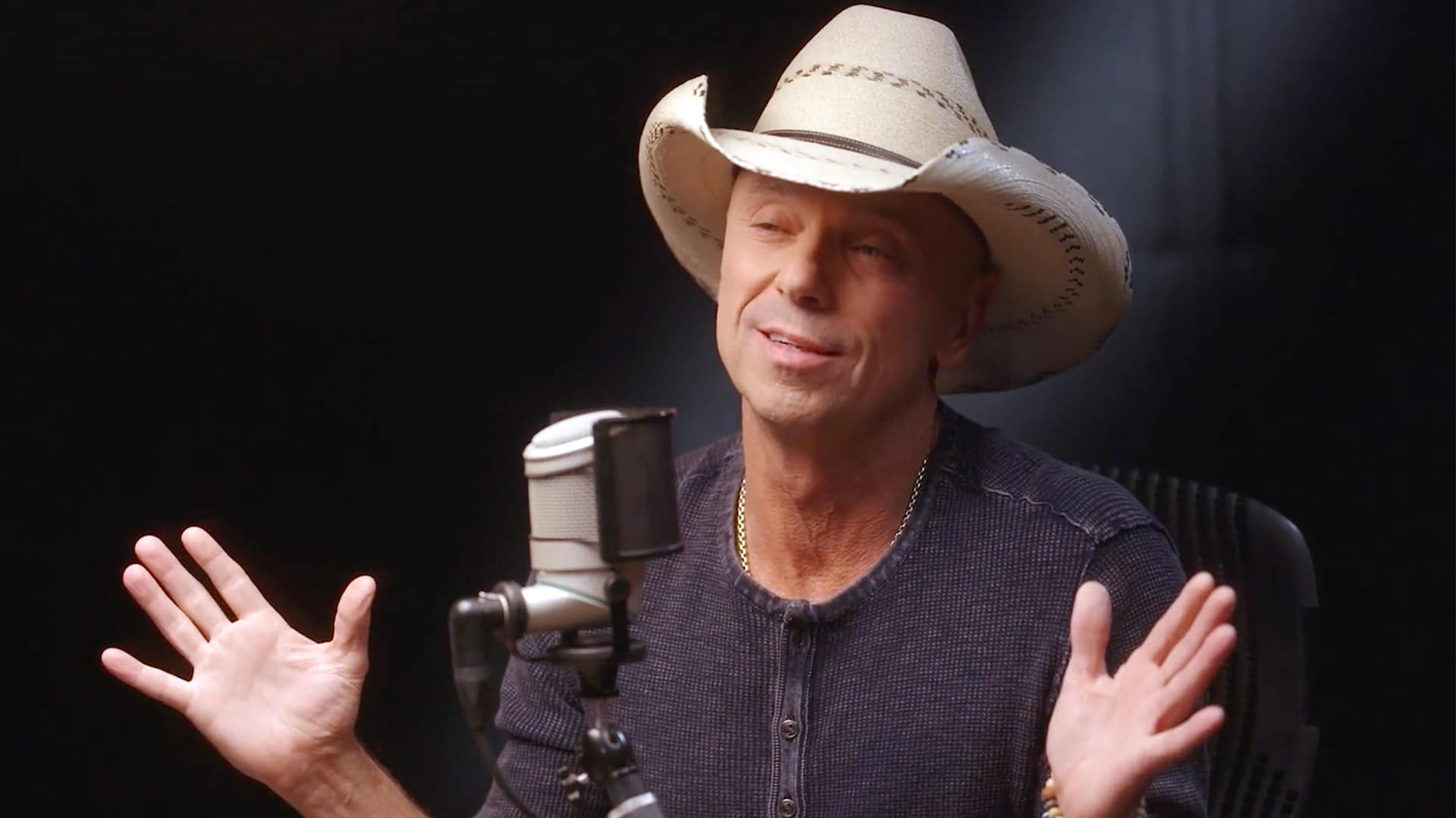 Kenny Chesney speaking during a podcast interview, opening up about his emotional connection with a Sandy Hook family.