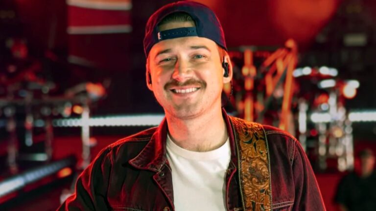 Morgan Wallen in a backward cap and denim jacket onstage, matching the momentum behind his early CMA award win before the 2025 show even begins.