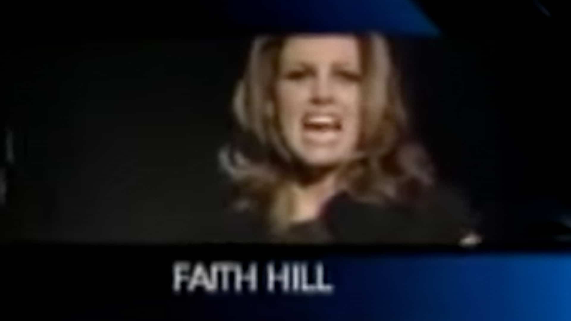 Faith Hill mid-reaction in a grainy award-show clip, echoing the shocked moment that fueled the infamous “WHAT?!” controversy at the 2006 CMAs.