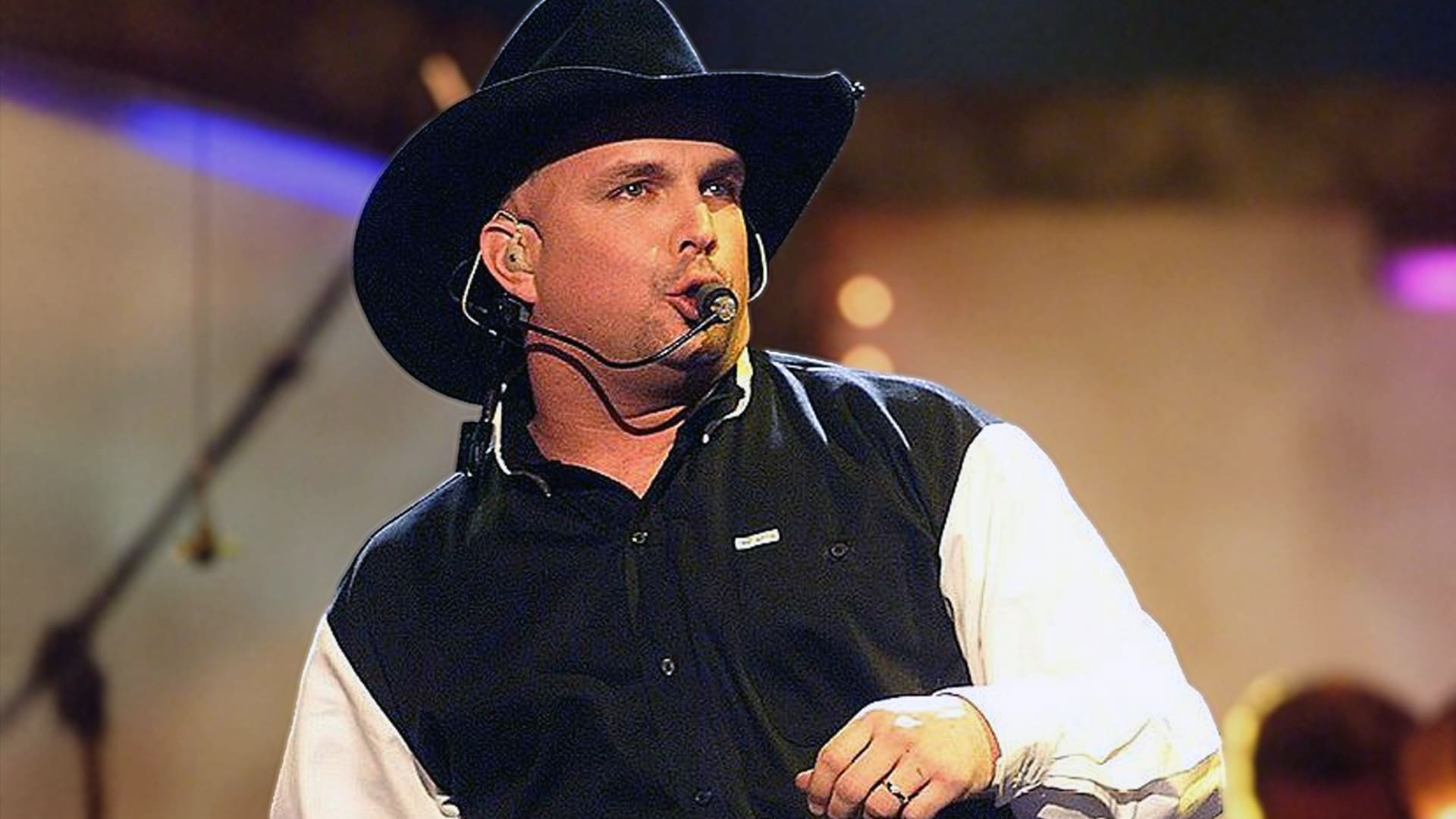 Garth Brooks in a black cowboy hat singing with a headset mic, capturing the larger-than-life force behind the live album that smashed sales records.