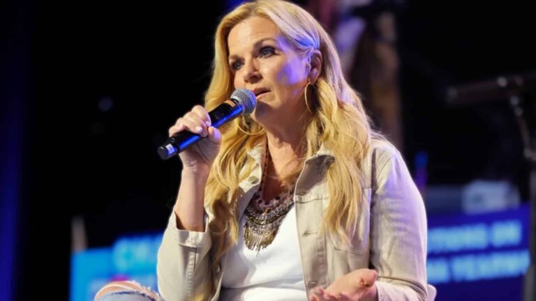 Trisha Yearwood speaking onstage with heartfelt candor, opening up about stepping back from her career for love and family with Garth Brooks.