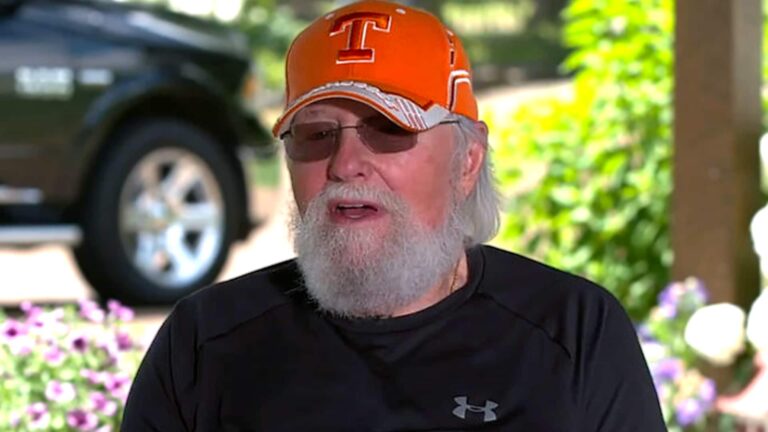 Charlie Daniels in an orange Tennessee Volunteers cap and black Under Armour shirt, reflecting on his big break as the last-minute session guitarist on Bob Dylan's groundbreaking 1969 album Nashville Skyline after Dylan's original player no-showed.