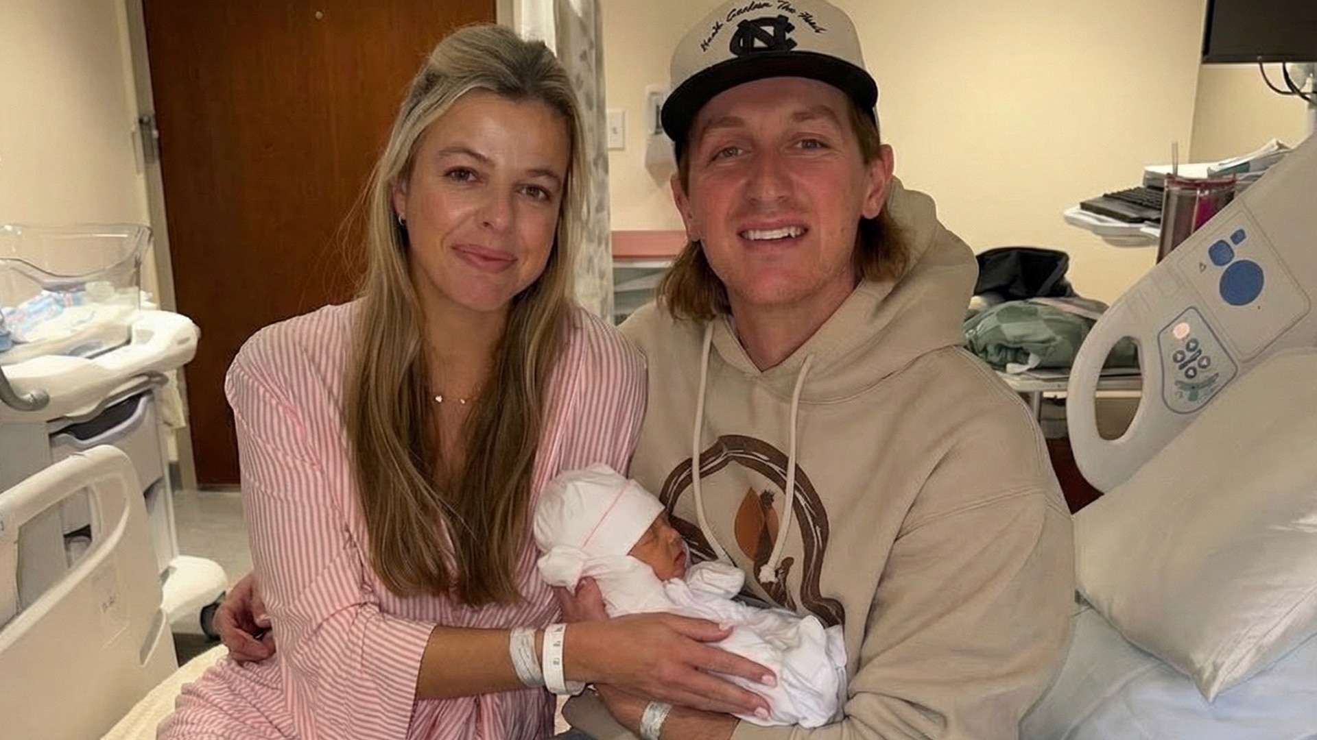 Country singer Cooper Alan and wife Hally welcome their first child, baby girl Coley Frances Cooper, smiling in hospital with newborn wrapped in white blanket, sharing sweet first photos of their family in December 2025.
