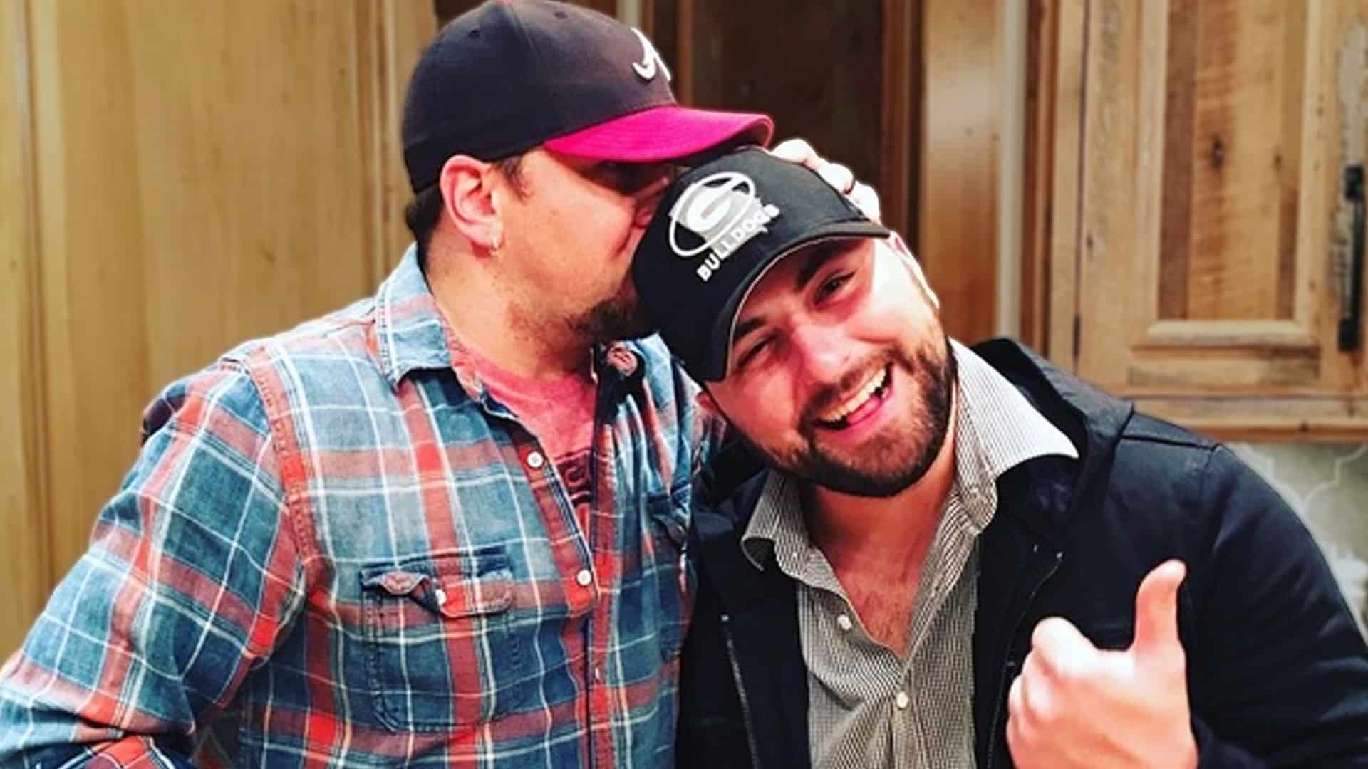 Tyler Farr and Jason Aldean share a laugh in a candid photo, as Tyler confesses to skinny-dipping and peeing in Aldean's pool during a 2025 interview, highlighting their deep country brotherhood and hilarious outlaw antics.