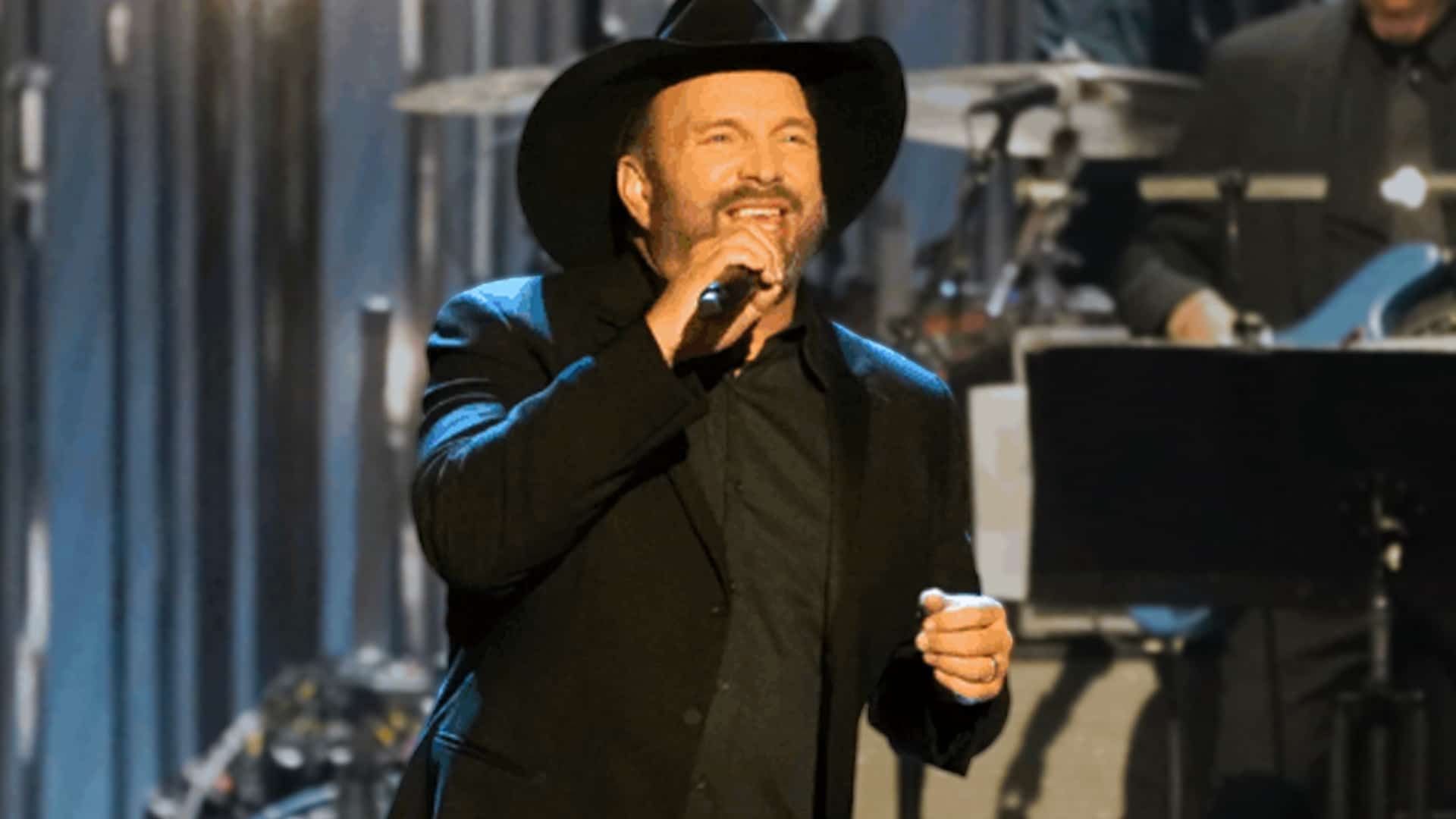 Garth Brooks performs a high-energy cover of KISS' "Shout It Out Loud" at the 2025 Kennedy Center Honors, wearing a black cowboy hat and suit while surprising the audience with rock instead of a George Strait tribute.