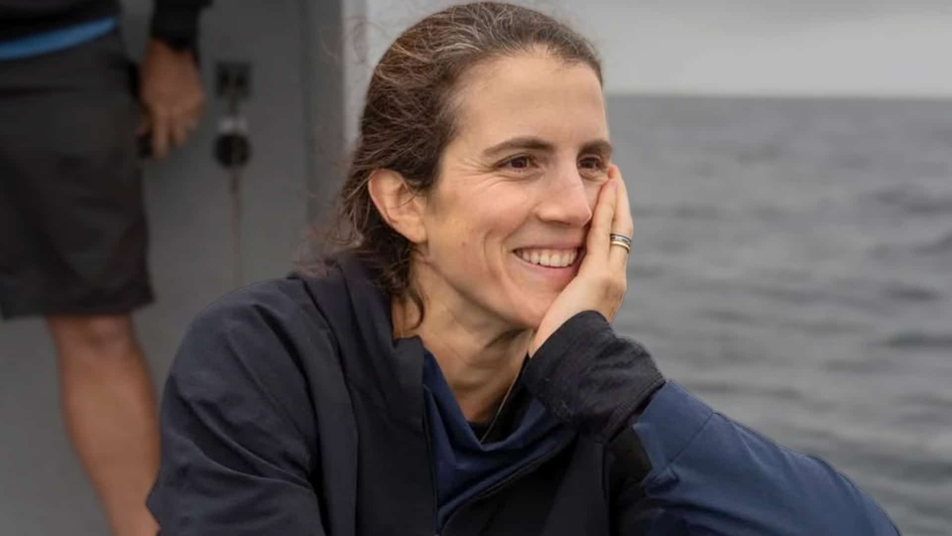 Tatiana Schlossberg, granddaughter of JFK and daughter of Caroline Kennedy, smiles softly in a candid photo by the water, remembered for her courageous battle with acute myeloid leukemia at age 35 in December 2025.