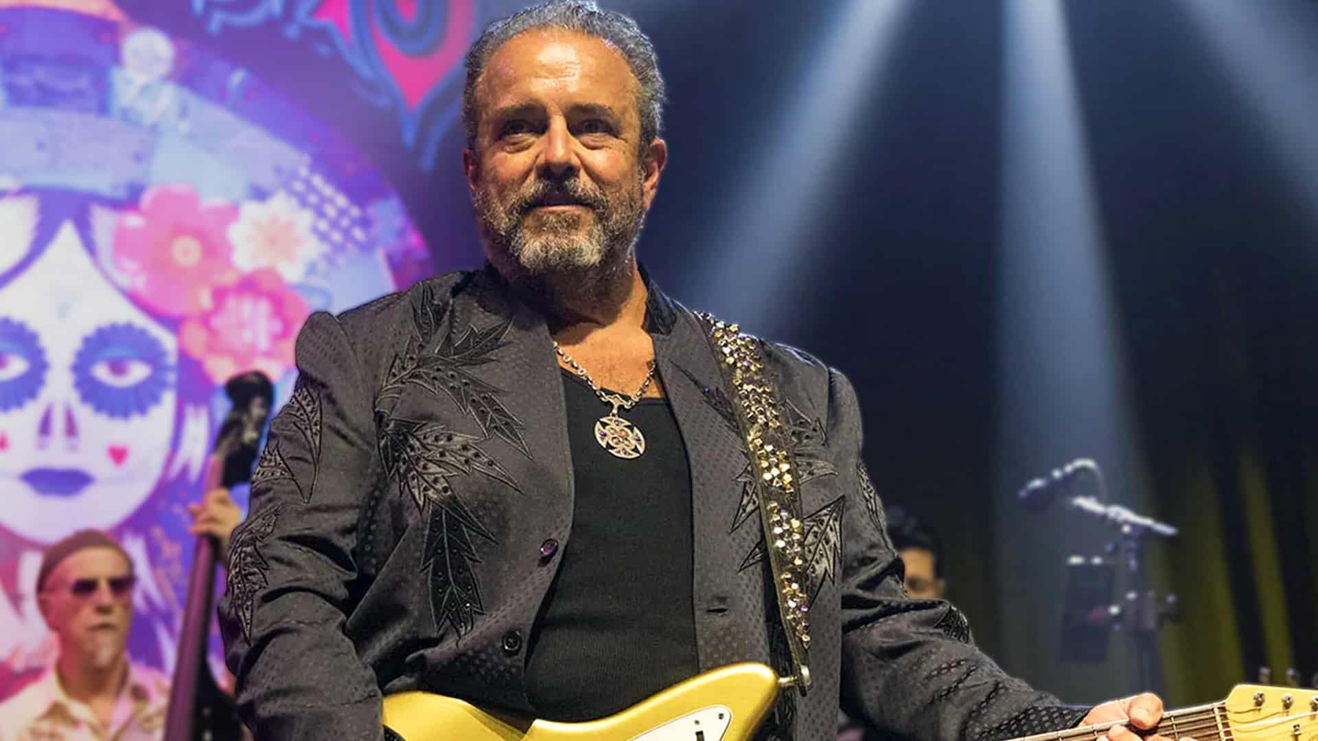 Raul Malo, legendary frontman of The Mavericks, performs on stage with gold guitar and embroidered jacket, as his public funeral service is announced for December 18, 2025, at Nashville's Cathedral of the Incarnation following his death at age 60.