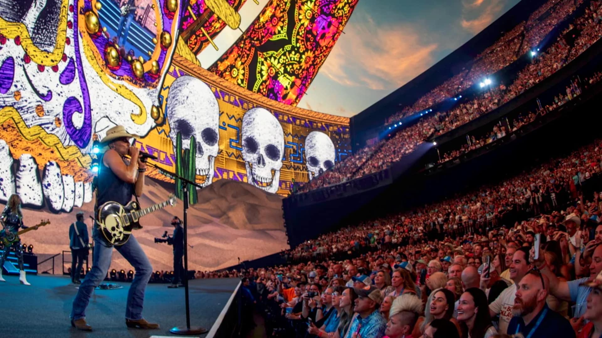 Kenny Chesney performs at the Las Vegas Sphere, dwarfed by psychedelic skull visuals that famously distracted him mid-song.