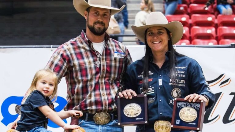 Kelsie Domer, WPRA champion breakaway roper, poses with husband and toddler daughter Oaklynn Rae Domer holding championship buckles and plaques at rodeo arena, days before tragic horse accident claims 3-year-old's life on February 19, 2026.