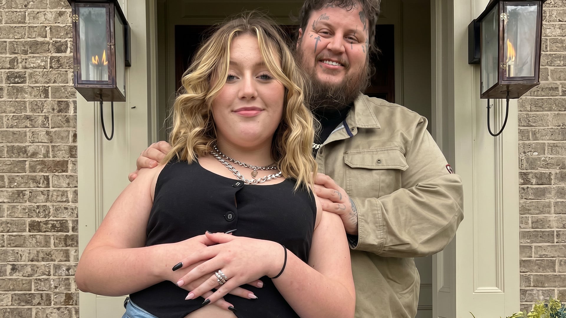 Jelly Roll standing with his teenage daughter Bailee Ann, the two posing together for a warm father and daughter photo.