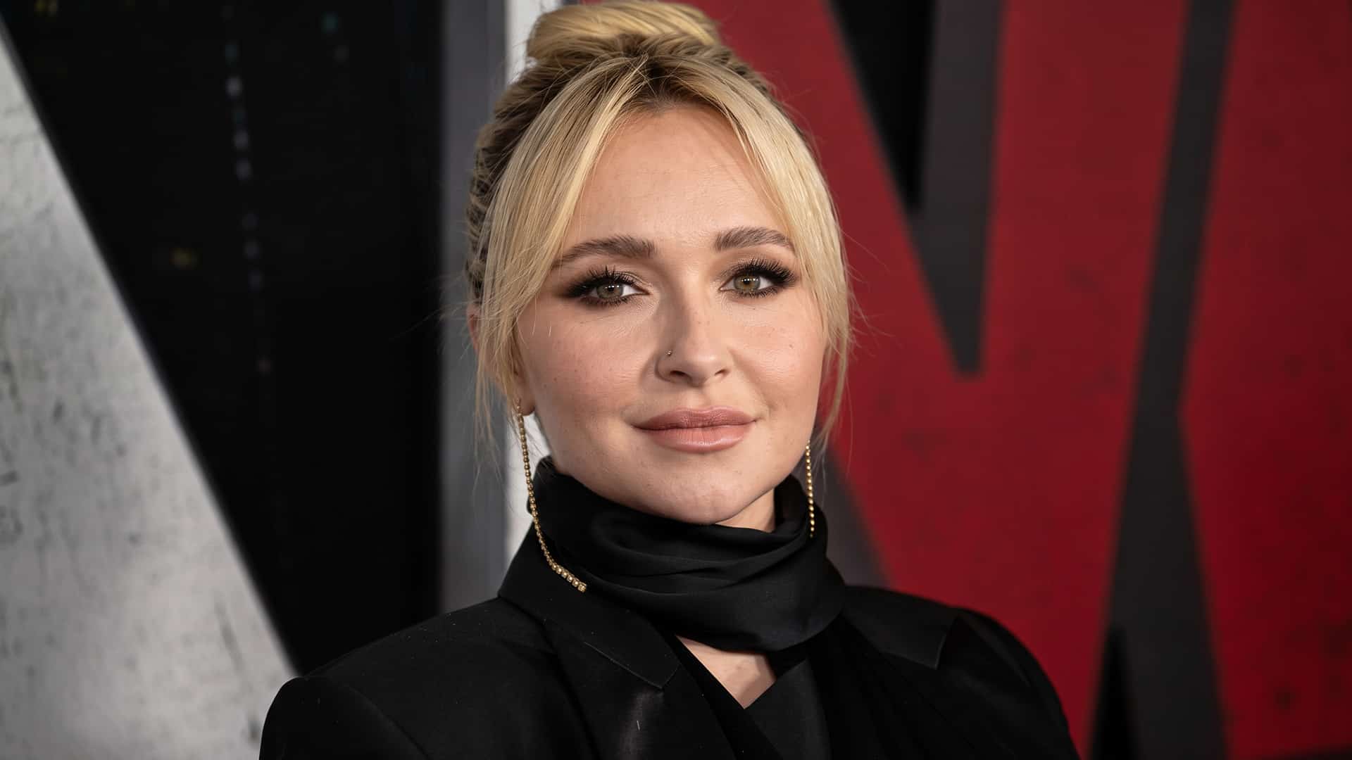Hayden Panettiere poses at an event in a black outfit as the coroner confirms her cause of death remains under investigation.