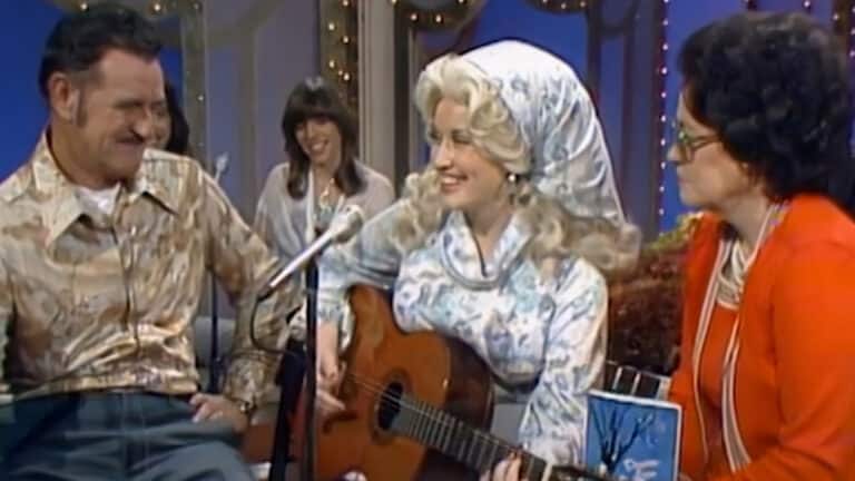 Dolly Parton poses with her parents and siblings as the story covers her brothers and sisters making music in her shadow and the song one brother wrote for his funeral.