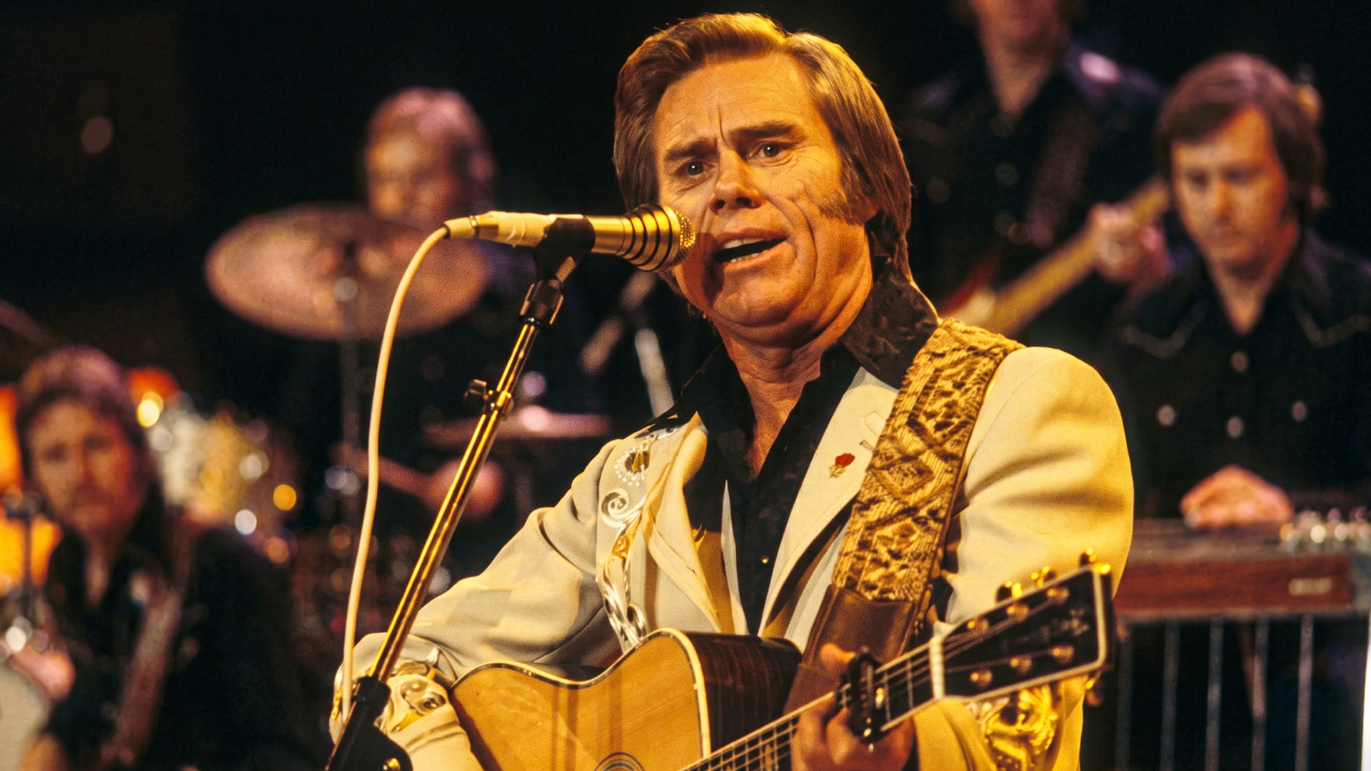 A photo of George Jones singing shows the legend who described “He Stopped Loving Her Today” as dark and bet against it hitting number one.