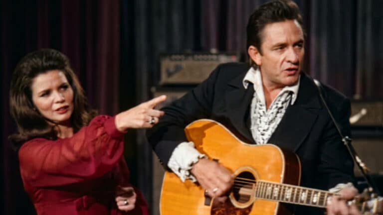 Johnny Cash and June Carter play onstage as Cash stopped his show to propose to her in front of about 7,000 people.
