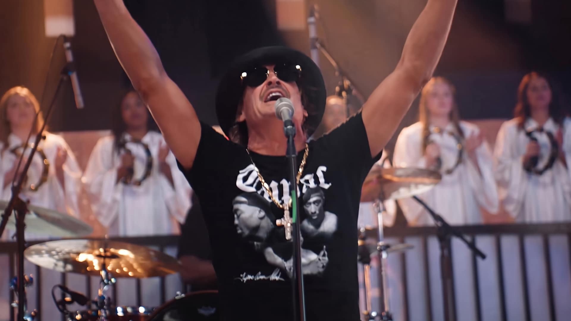 Kid Rock is shown worshiping in his music video as he admits AI helped build the choir on his gospel album Halfway 2 Jesus and calls it another tool.