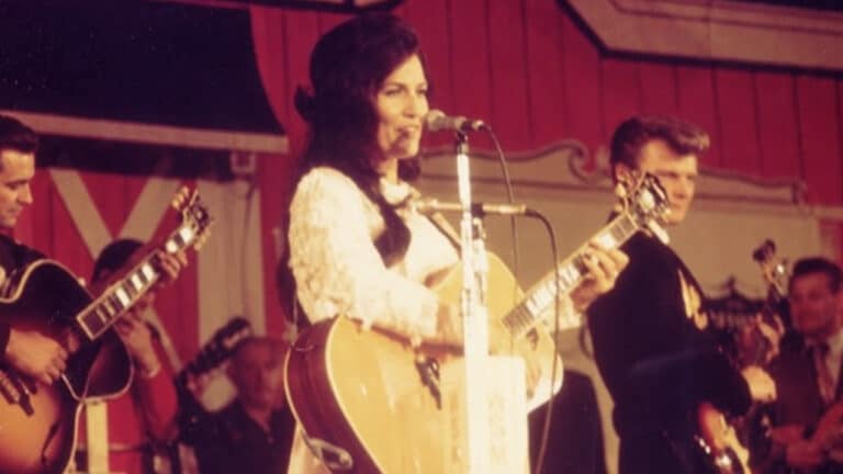 A photo of young Loretta Lynn on the Opry stage after she slept in a car before her Grand Ole Opry debut and woke to a sight she could not believe.