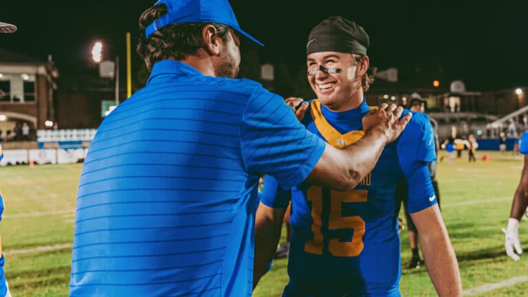 Luke Bryan stands with his son Bo as the high school senior suffers a collarbone injury in the season he long anticipated, then offers fans a promise.