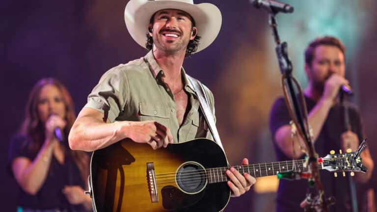 Riley Green appears with his openers in the background while sharing why he brings them onstage and the advice Brad Paisley gave him.