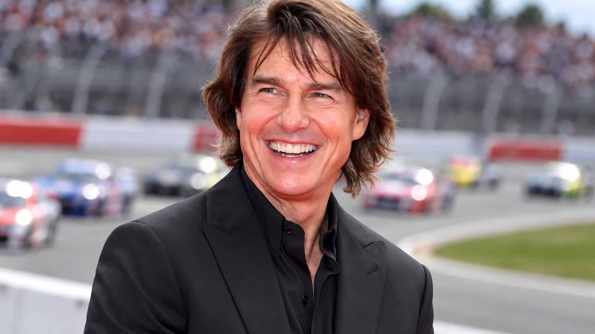 Tom Cruise smiles as he wants to run a real ARCA race at 64 for Days of Thunder 2 and NASCAR’s CEO admits he was shocked.