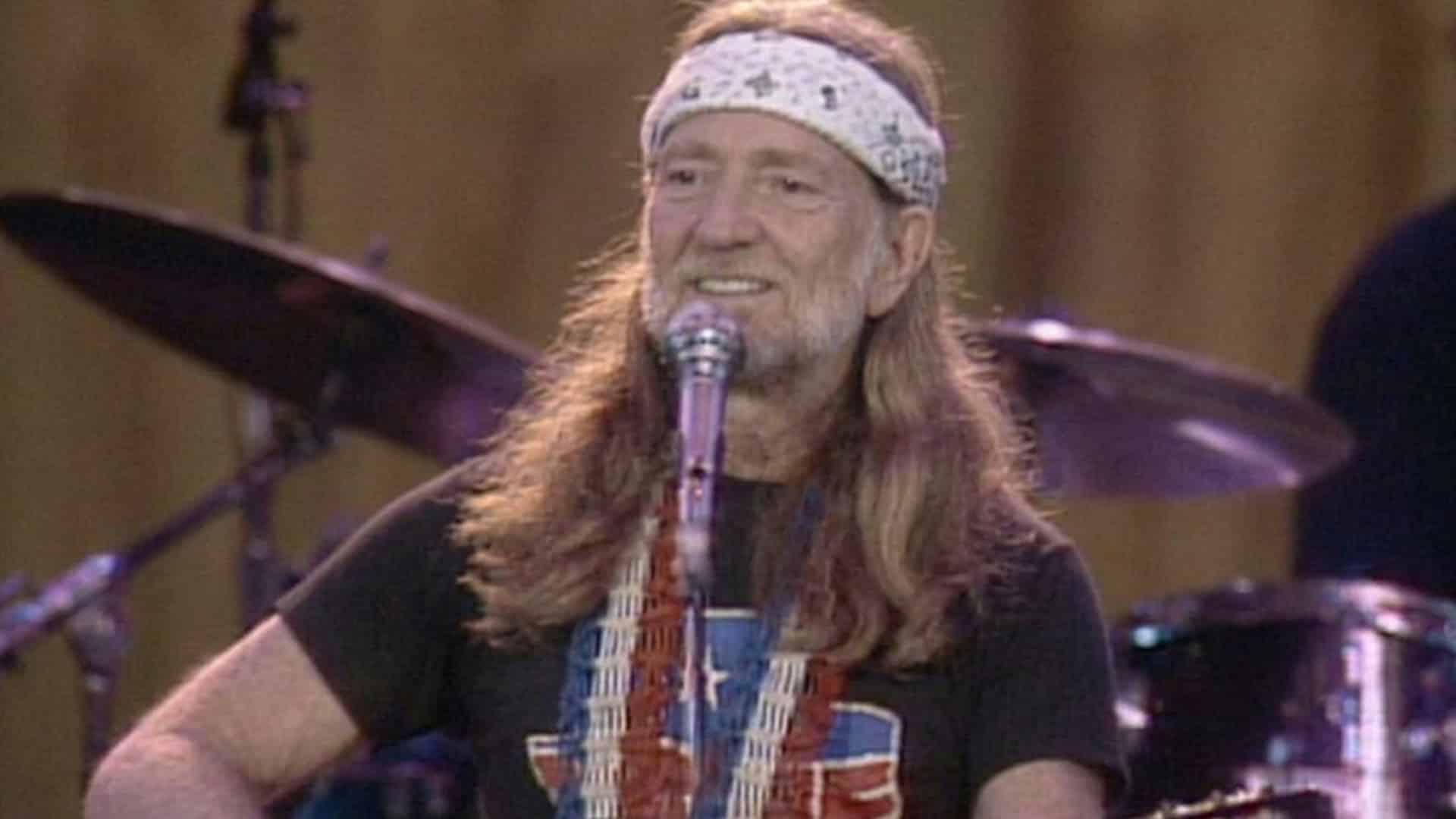 A photo of young Willie Nelson performing after his IRS Tapes album was made from something the government had already taken from him.